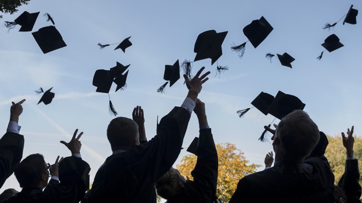 Graduates throwing caps in the air