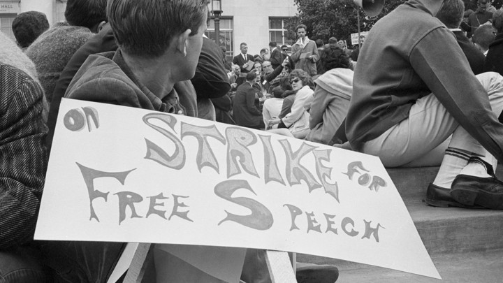 College student holding "On Strike for Free Speech" sign at protest