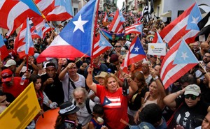 A crowd waving Puerto Rican flags