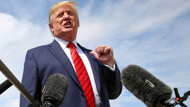 Donald Trump speaks into a microphone.