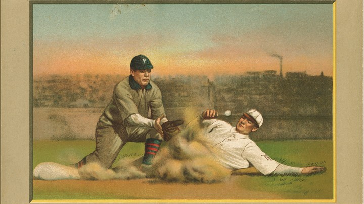 A baseball player sliding into a base