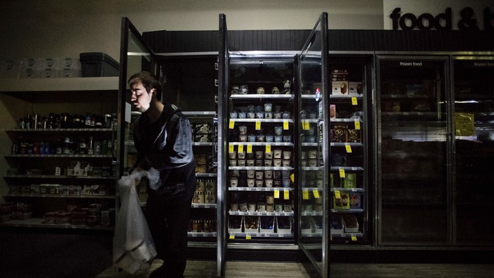 A darkened freezer section of a convenience store.