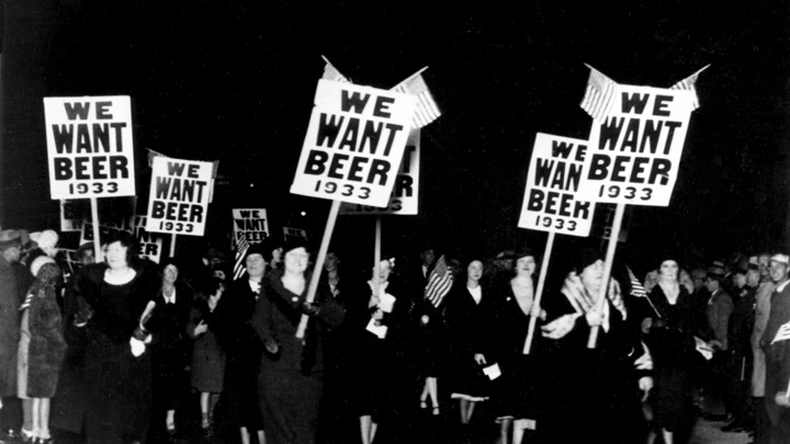 Women march holding "We Want Beer" signs in an anti-Prohibition parade in 1932.