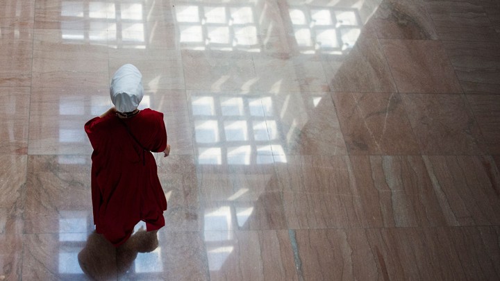 Protester dressed as a Handmaid