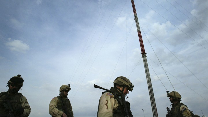 U.S. forces stand in front of Mosul TV-station transmitters.