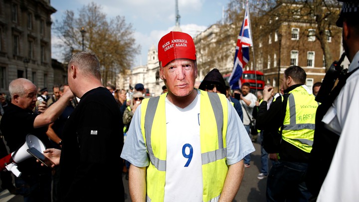 Pro-Brexit yellow vest protester in Trump mask