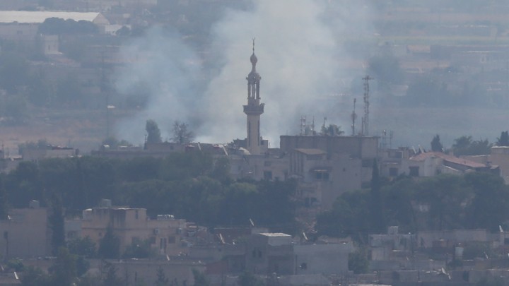 Smoke rises over the Syrian town of Ras al-Ain.