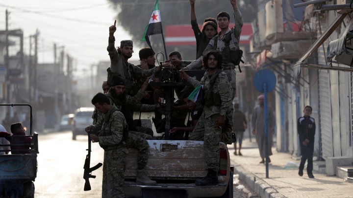 Syrian rebel fighters at the back of a truck