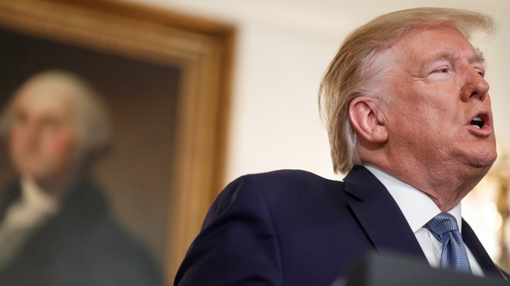 U.S. President Donald Trump delivers a statement on the conflict in Syria in front of a portrait of former President George Washington in the Diplomatic Room of the White House.