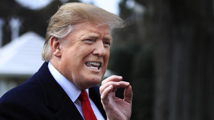 President Donald Trump speaks with reporters before leaving the White House.