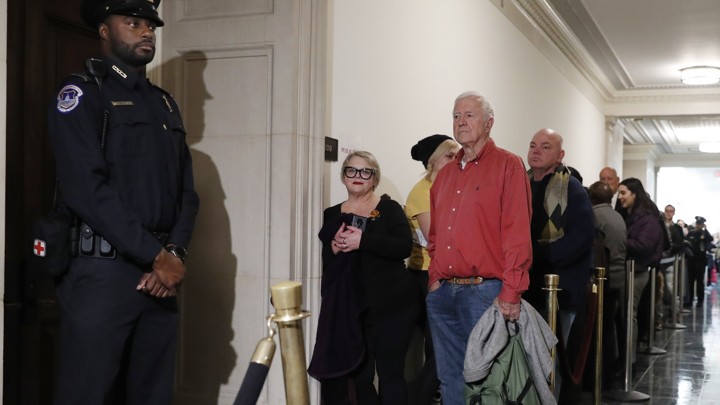 Members of the public wait in line hoping to get into the hearing room as former U.S. Ambassador to Ukraine Marie Yovanovitch arrives to testify.