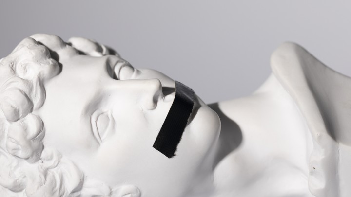 A 16th-century Michelangelo sculpture with black tape over the figure's mouth