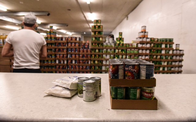 Factory worker stacking cans