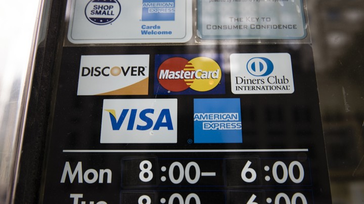 A sign with the logos of various credit-card companies