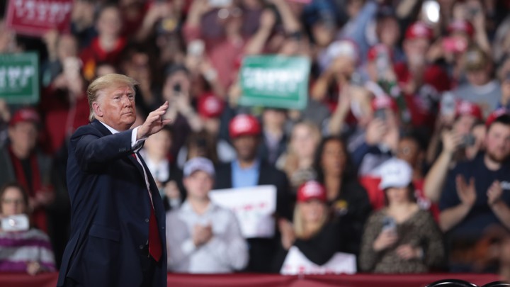 Donald Trump at a rally in Michigan. He is standing in front of a crowd.