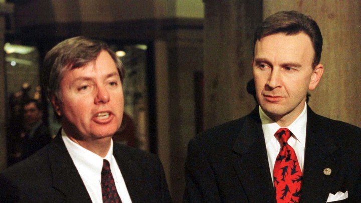 Then-Representatives Lindsey Graham and James Rogan speak with the press during the impeachment trial of former President Bill Clinton