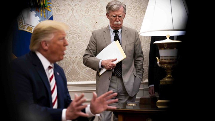 John Bolton, the national-security adviser, watches as President Donald Trump host the Romanian president in the Oval Office.