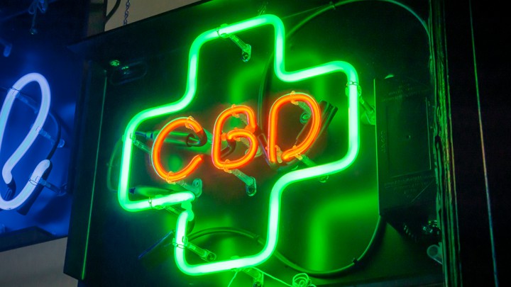 A green-and-red neon sign for CBD
