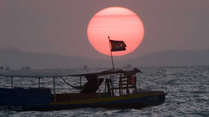 A fishing boat near Sihanoukville flies the Cambodian flag.