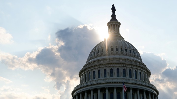 The dome of the U.S. Capitol building with the sun shining through it.