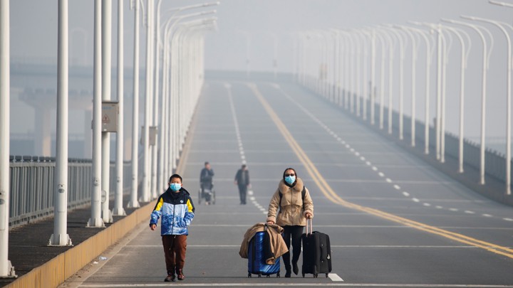 Mother and son with face masks approach checkpoint