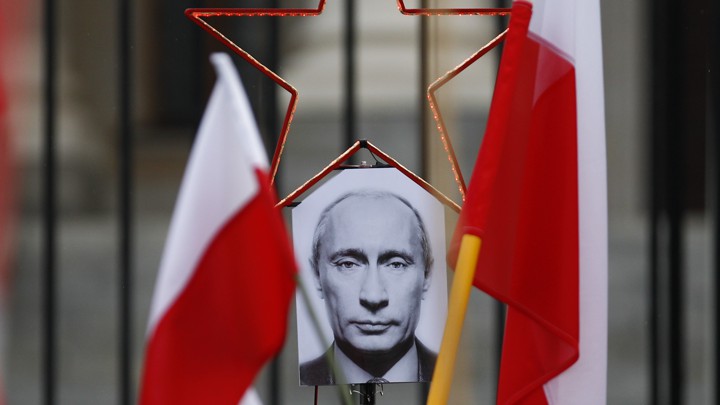 A photo of Russian President Vladimir Putin between two Polish flags
