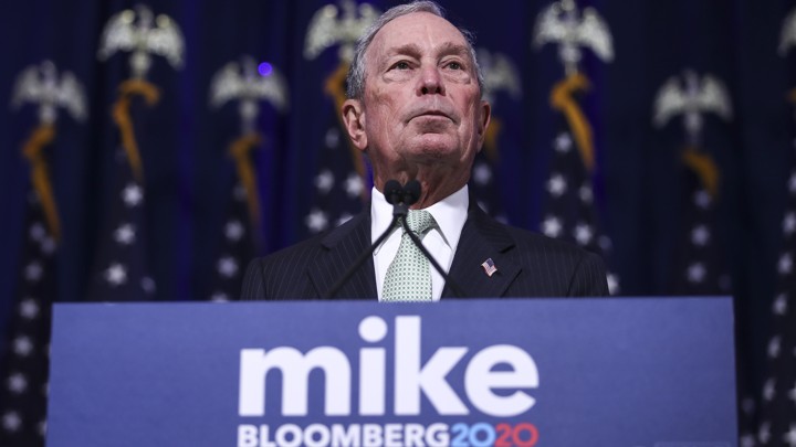 Michael Bloomberg stands at a lecturn.
