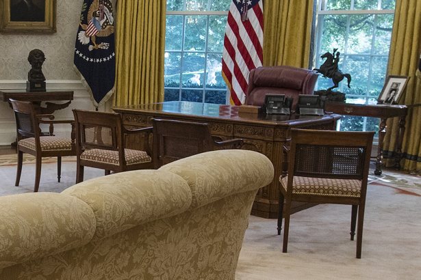 One desk, one big chair, four little chairs.