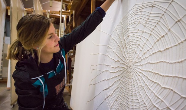 Artist Richelle Gribble with her cotton spider web on kozo washi paper, created during her artist-in-residency in Japan