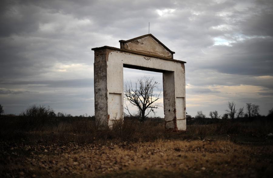 the main gate of an abandoned cooperative farm