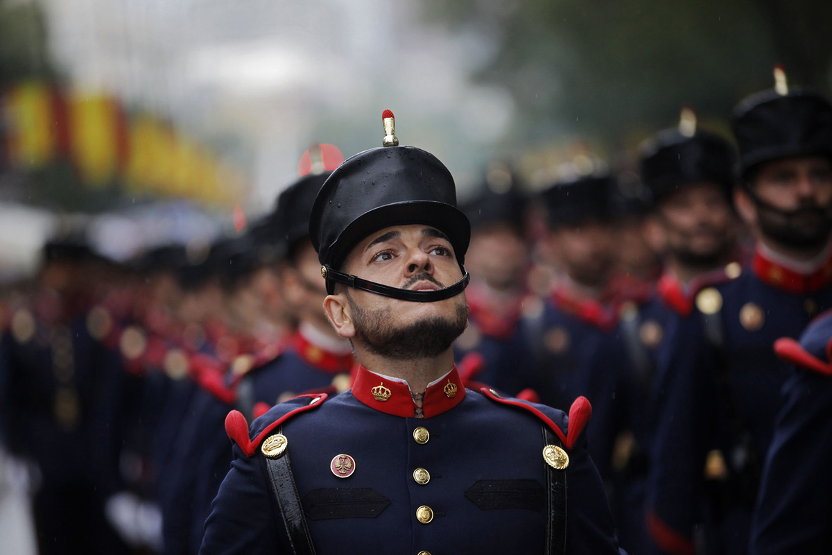 a-spanish-soldier-looks-up-as-he-marches-with-others-in-a-military