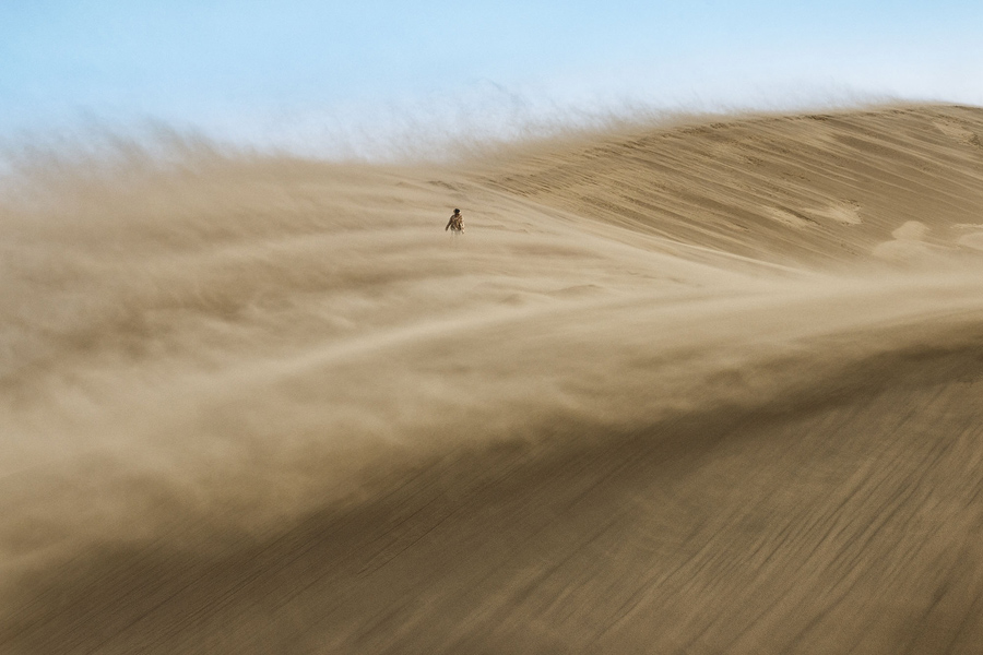  Wanderer - Sandstorm on the Singing sand dune, national Park Altyn-Emel, Kazakhstan. # © Alesya Osadchaya / National Geographic Travel Photographer of the Year Contest