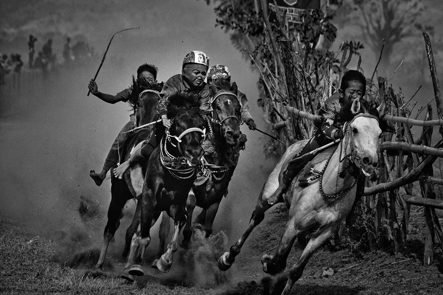 Child jockeys (aged five through 10) ride bareback, barefoot, and with little protective gear, on small horses, during traditional Maen Jaran horse races, on Sumbawa Island, Indonesia. # Alain Schroeder / Reporters 