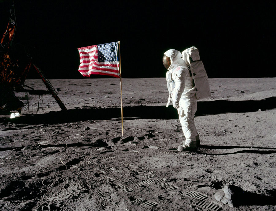 The astronaut Edwin E. Aldrin Jr., the lunar-module pilot of the first lunar-landing mission, poses for a photograph beside the deployed United States flag during an Apollo 11 extravehicular activity (EVA) on the lunar surface on July 20, 1969.