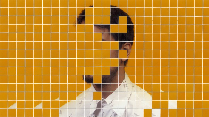 A tiled image of a person's upper body with the face obscured