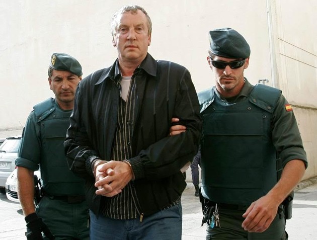 Police officers accompany Gennady Petrov after his arrest on the island of Mallorca in 2008. (Dani Cardona/Reuters)