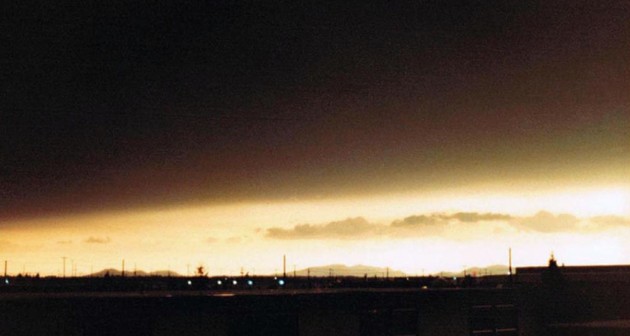 A dark ash cloud from the Mt. St. Helens eruption looms over the horizon on May 18, 1980, at Fairchild Air Force Base.