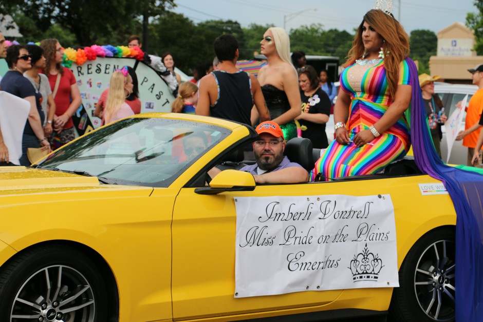 Imberli Vontrell rides in a convertible during Pride on the Plains