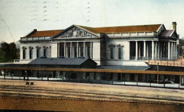 An old photograph of Burlington Station, showing its pillars, tall roof and grand stature.