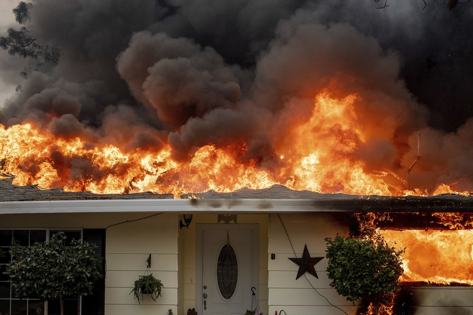 Flames engulf a roof in Paradise, California. 