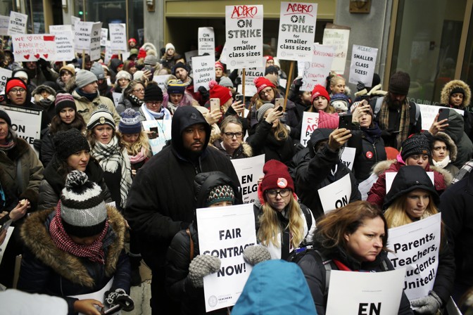 A group of people protest against Acero schools in front of Chicago Public Schools headquarters