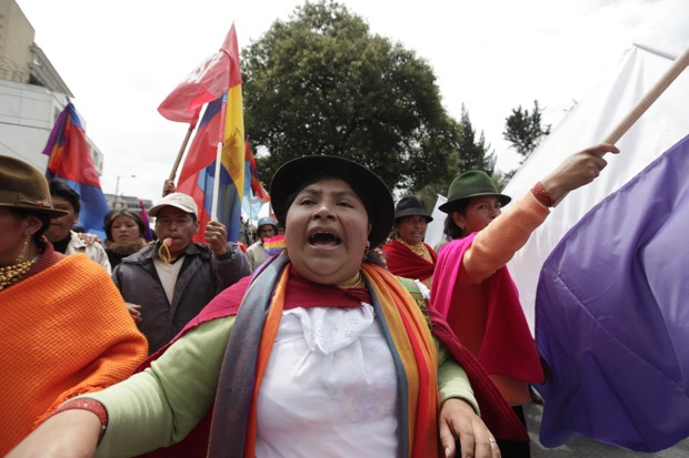 a woman protesting water privatization in Ecuador