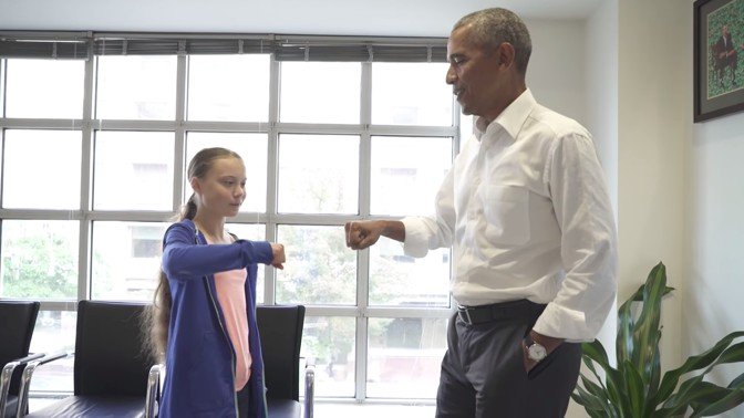 Climate activist Greta Thunberg meets former President Barack Obama’s fist in the air with her fist.