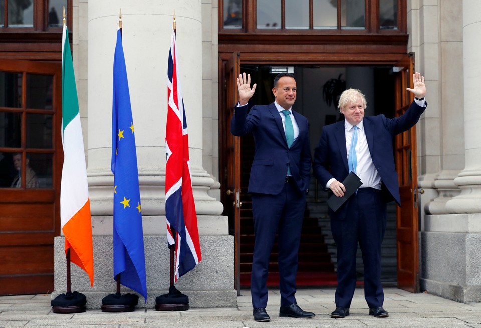Boris Johnson and Leo Varadkar stand next to flags of the United Kingdom, the Republic of Ireland and the European Union.