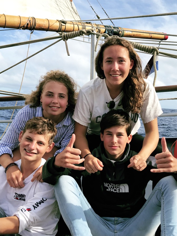 A photo of the friends on the boat.