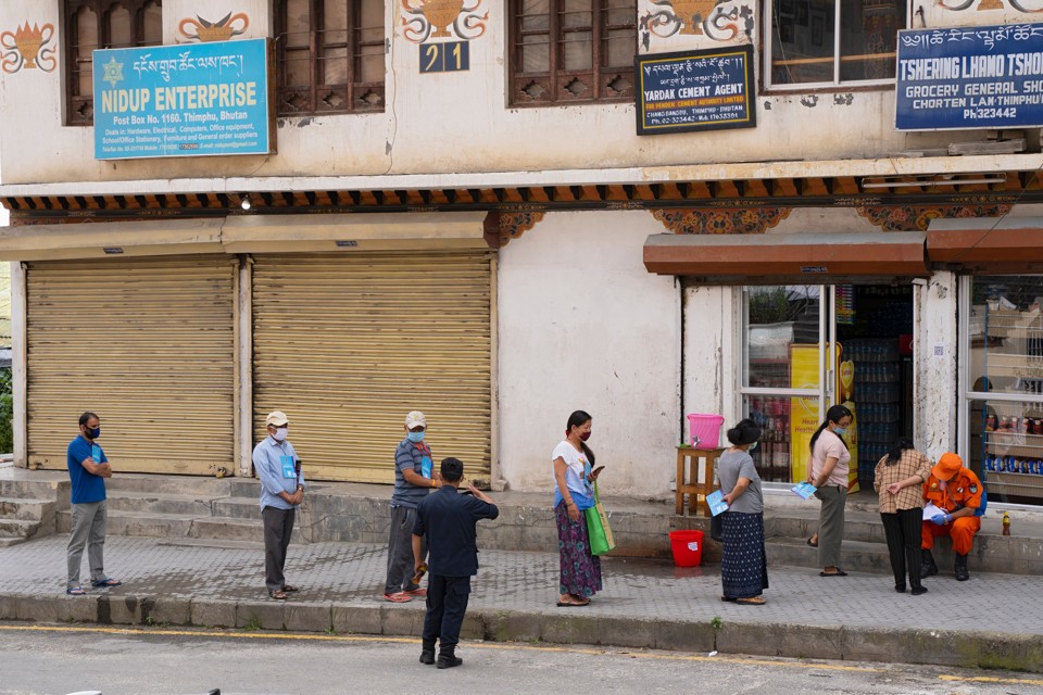 Local residents maintain social distancing as they stand in a queue to buy groceries outside a store during a nationwide lockdown imposed as a preventive measure against the spread of the COVID-19 coronavirus at Thimphu in Bhutan, on August 20, 2020.