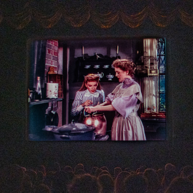 A movie theater with viewers watching a film. 