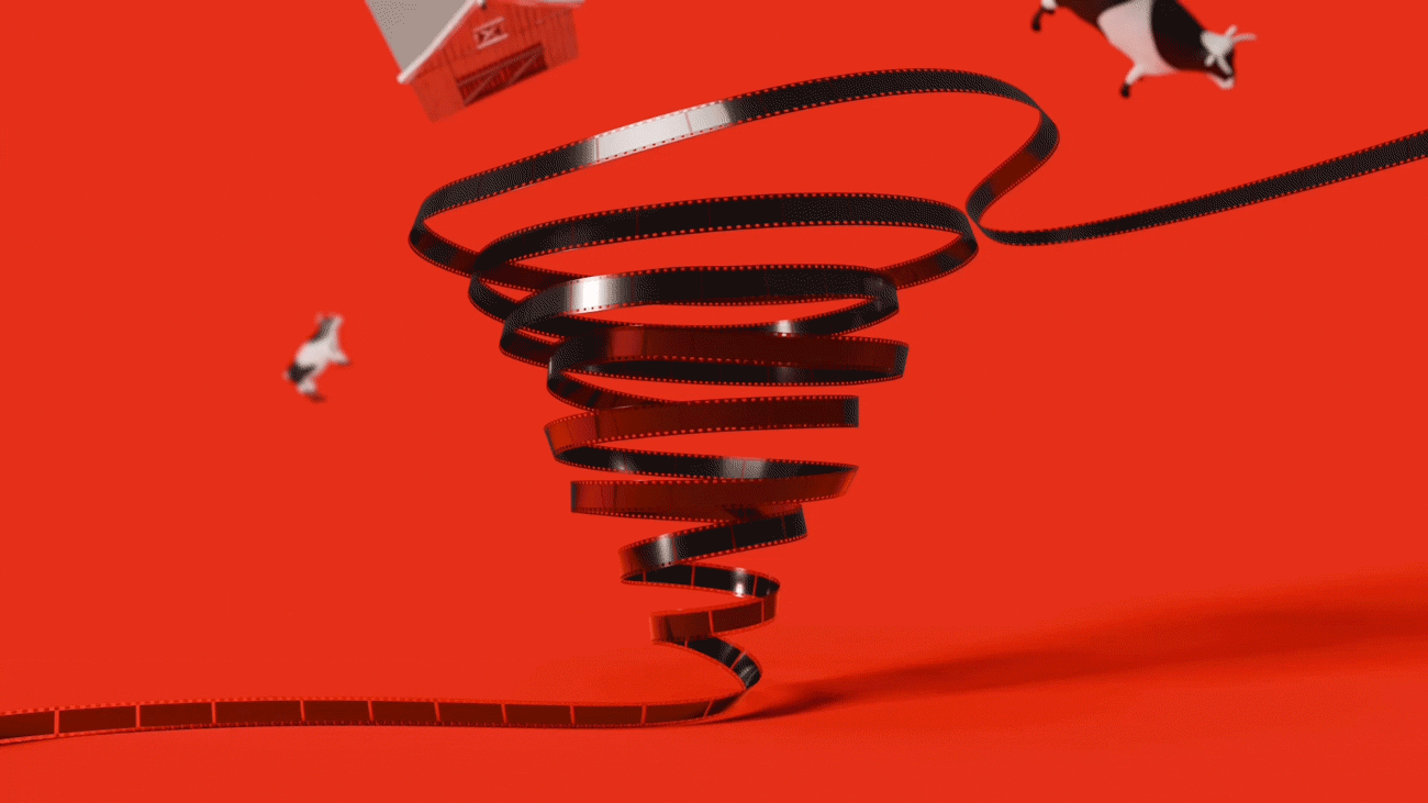 An animation of a film reel in the shape of a tornado with cows and a barn floating around it