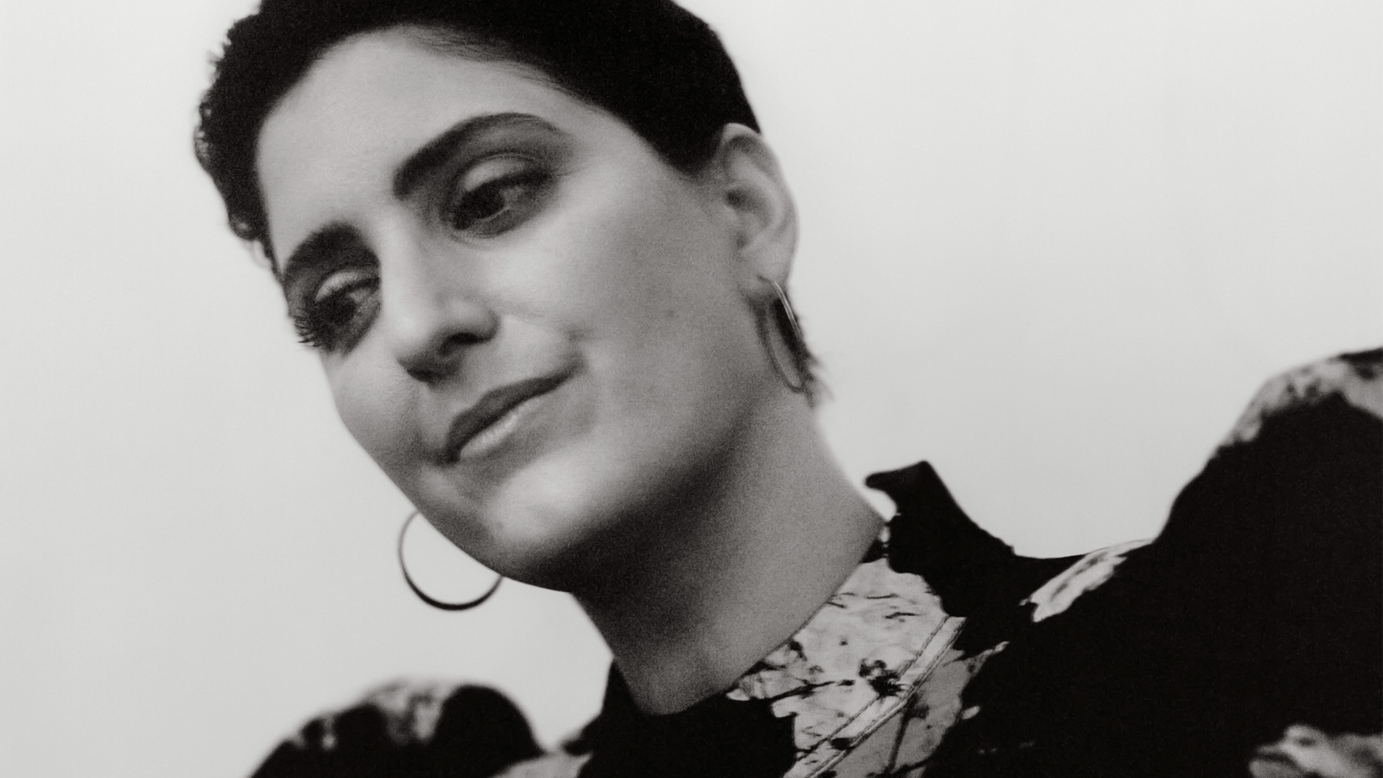 black-and-white photo of woman with short dark hair smiling