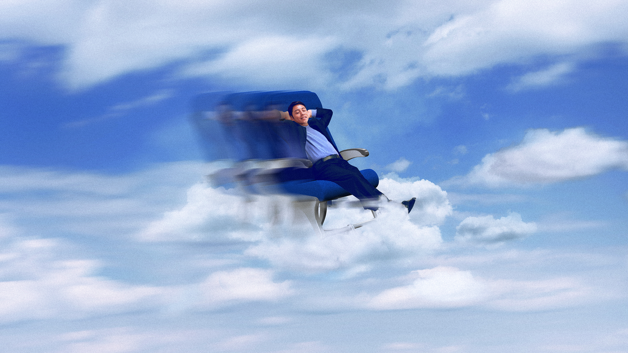 A man relaxing on a plane seat hovering among clouds in a blue sky